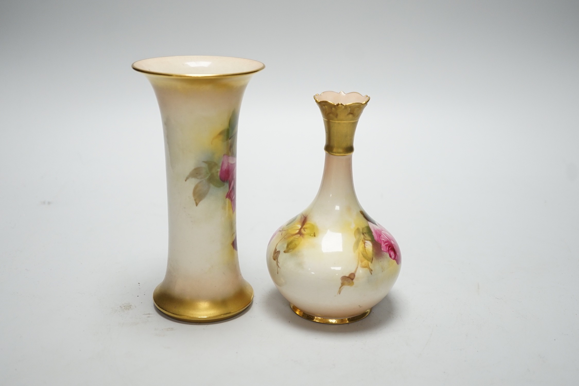 A Royal Worcester trumpet vase, shape G923 painted with roses by M. Hunt, signed, date code 1925 and another vase, shape G702 painted with roses, date code 1924, tallest 16cm